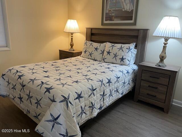 bedroom featuring light wood-style floors, a closet, and ornamental molding