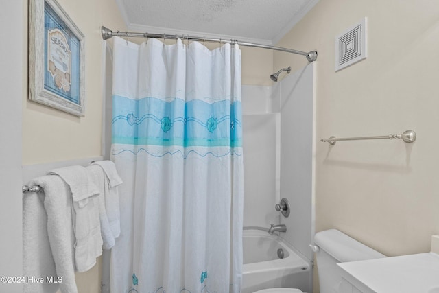 full bathroom featuring vanity, a textured ceiling, shower / tub combo with curtain, and crown molding