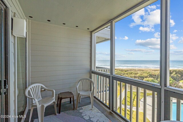 view of water feature with a view of the beach and fence