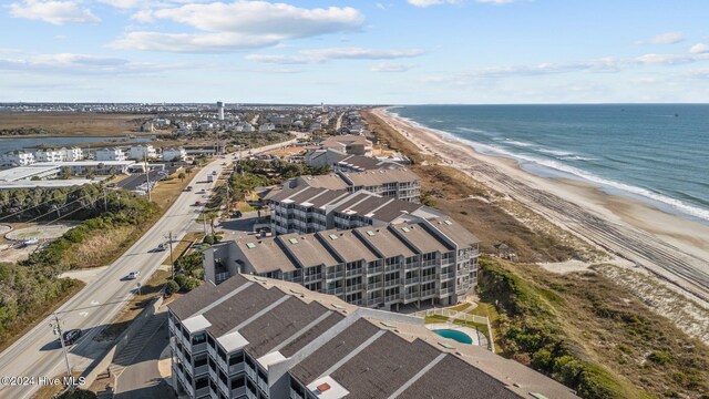 view of community with a water view and a beach view