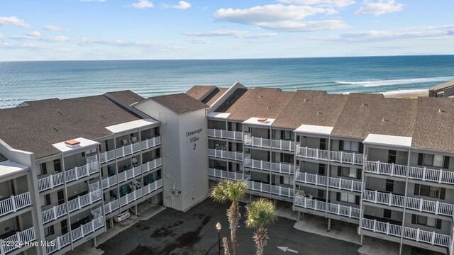 bird's eye view with a water view and a beach view