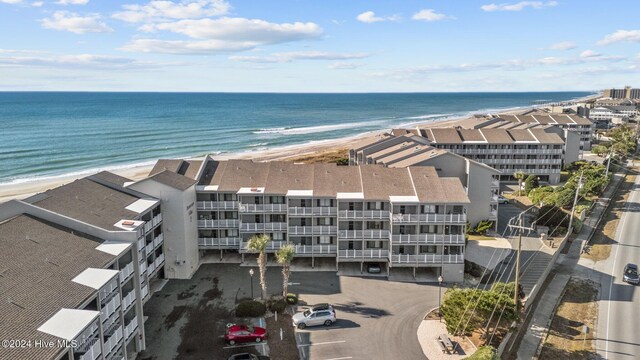 birds eye view of property with a water view and a view of the beach