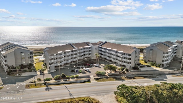 birds eye view of property featuring a water view and a beach view