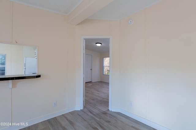 interior space featuring light wood-type flooring and ornamental molding