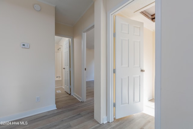 hallway with light hardwood / wood-style floors