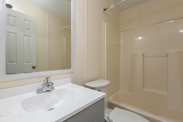 full bathroom with vanity, a textured ceiling, toilet, and shower / bathtub combination