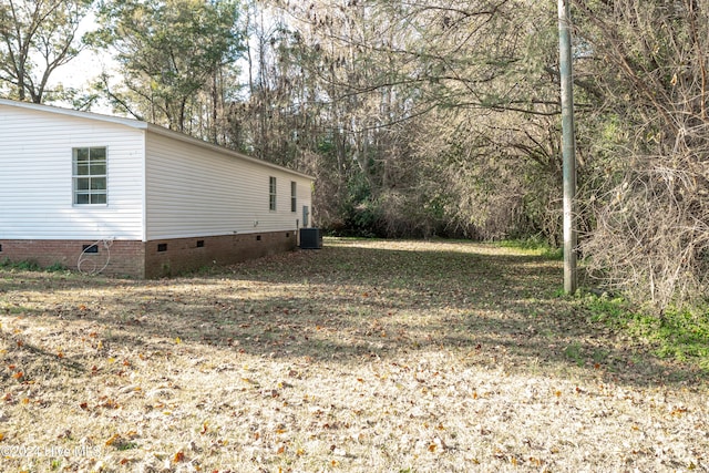 view of side of home featuring central AC