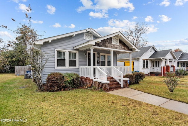 bungalow-style house with covered porch and a front yard