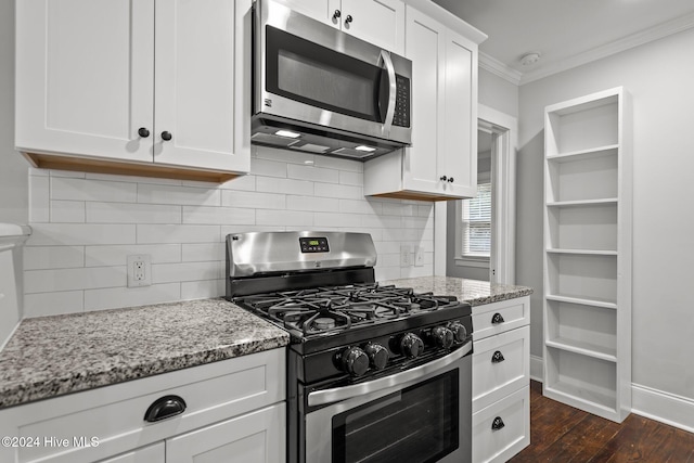 kitchen featuring dark hardwood / wood-style floors, light stone countertops, ornamental molding, appliances with stainless steel finishes, and white cabinetry