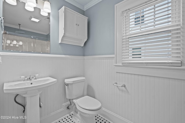 bathroom featuring tile patterned floors, crown molding, and toilet