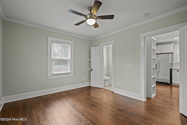 unfurnished bedroom featuring ensuite bath, ceiling fan, dark hardwood / wood-style floors, stainless steel fridge, and crown molding