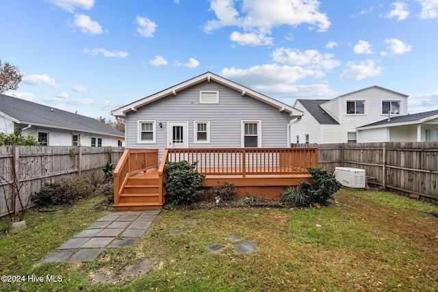 back of house featuring a yard and a wooden deck