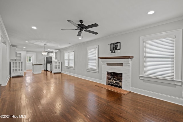 unfurnished living room with crown molding, ceiling fan, and dark hardwood / wood-style floors