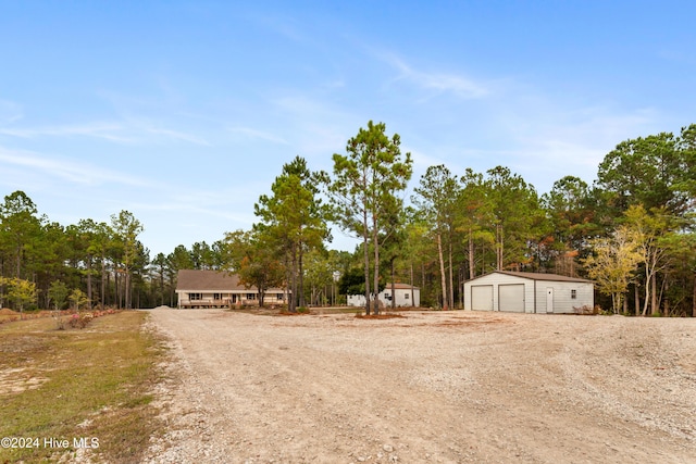 view of yard with a garage and an outdoor structure