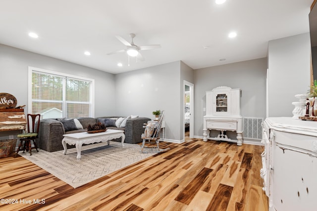 living room with ceiling fan and light hardwood / wood-style floors