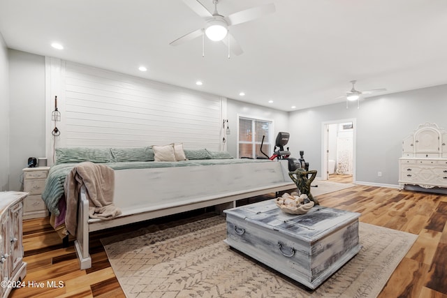 bedroom featuring ceiling fan, ensuite bathroom, and light hardwood / wood-style floors