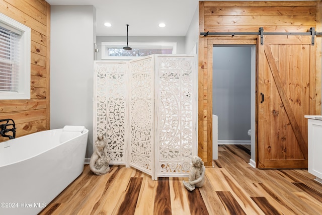 bathroom featuring wood-type flooring, shower with separate bathtub, and wooden walls