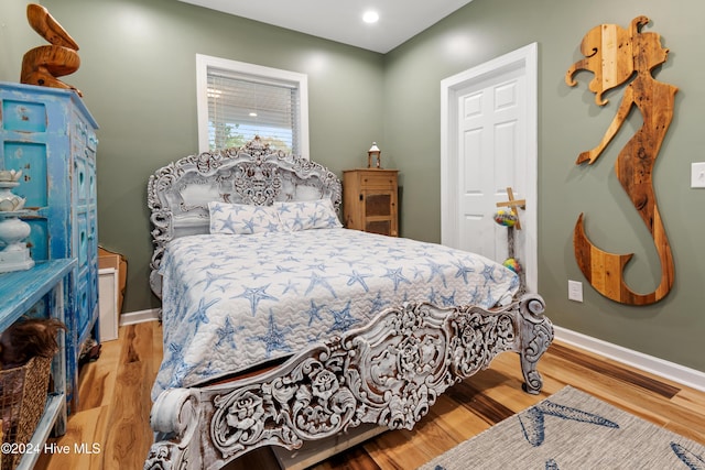 bedroom with light hardwood / wood-style flooring