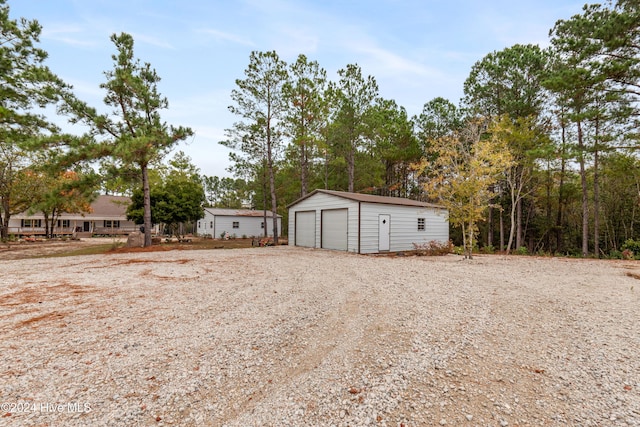 view of yard with a garage and an outdoor structure