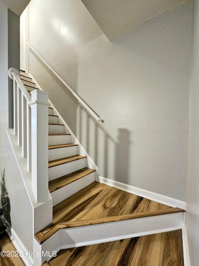 staircase featuring hardwood / wood-style floors