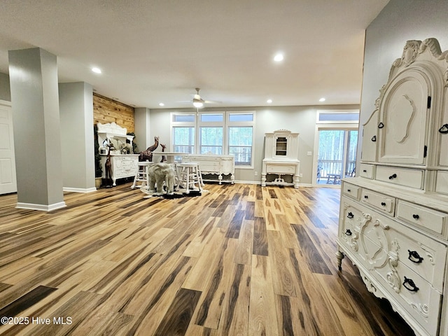 interior space featuring wood-type flooring, plenty of natural light, and ceiling fan