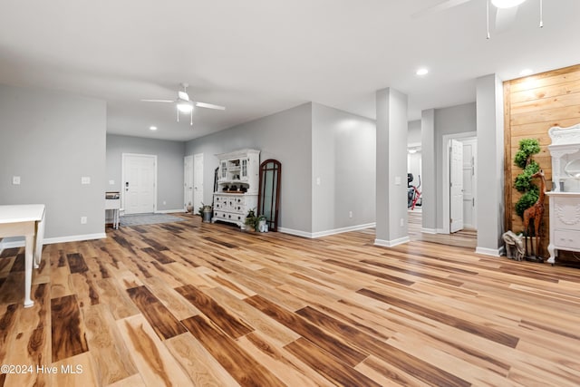 unfurnished living room featuring ceiling fan and light hardwood / wood-style flooring