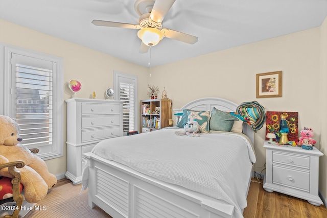 bedroom with ceiling fan and hardwood / wood-style floors