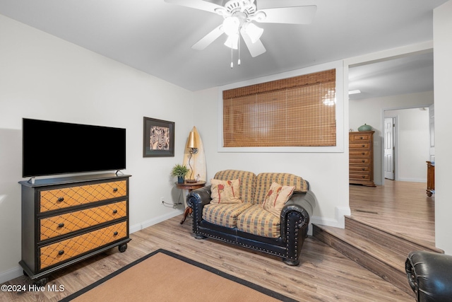 sitting room with light hardwood / wood-style floors and ceiling fan