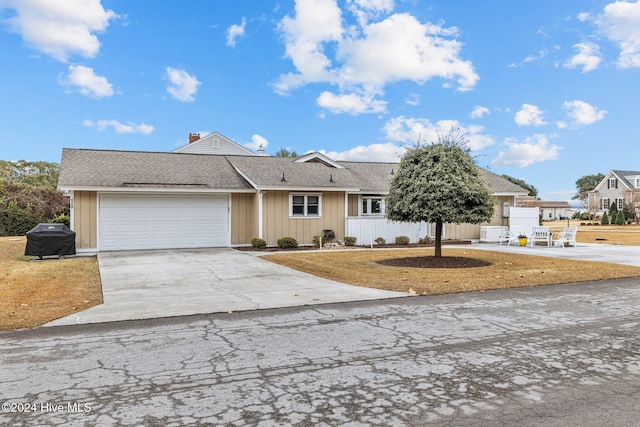 single story home featuring a front yard and a garage