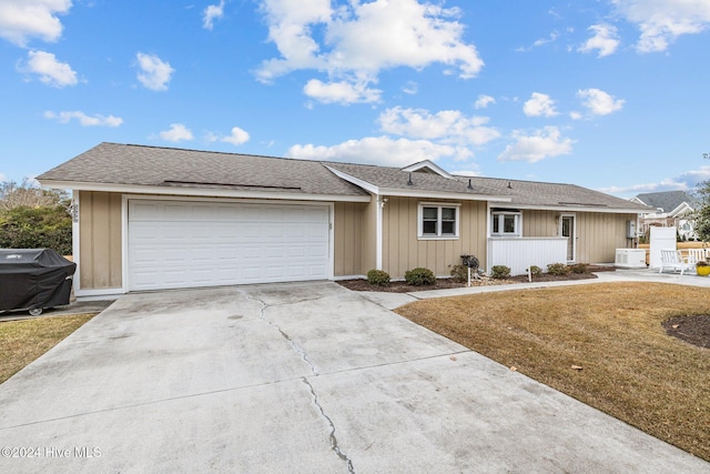 ranch-style home with a front yard and a garage