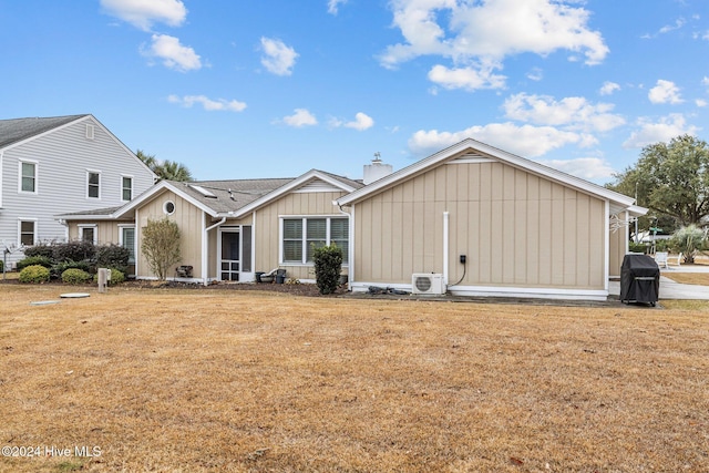 back of house featuring a yard and ac unit