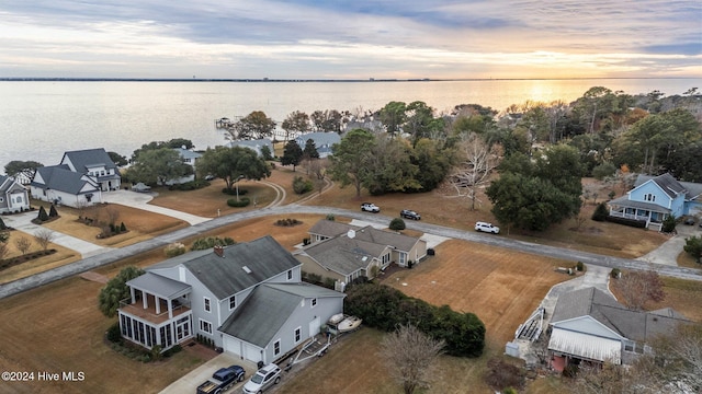 aerial view at dusk with a water view