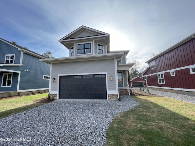 view of front property featuring a front yard and a garage