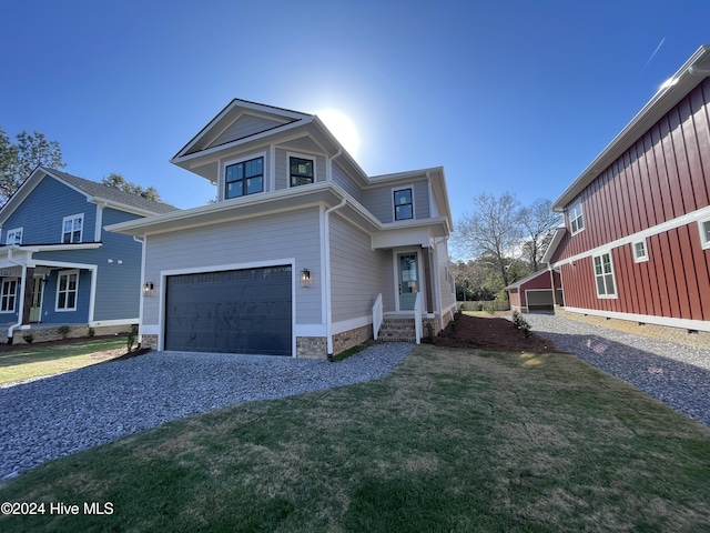 view of front of house featuring a front lawn and a garage