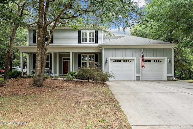 view of front property featuring covered porch and a garage