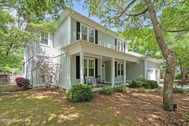 view of front of home featuring a porch, an attached garage, fence, and board and batten siding