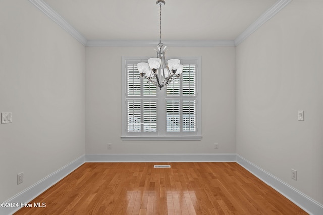 spare room featuring light hardwood / wood-style flooring, plenty of natural light, and ornamental molding