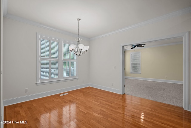 unfurnished room with ceiling fan with notable chandelier, hardwood / wood-style flooring, and ornamental molding