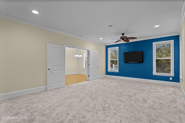 unfurnished bedroom featuring crown molding, light colored carpet, and ceiling fan with notable chandelier