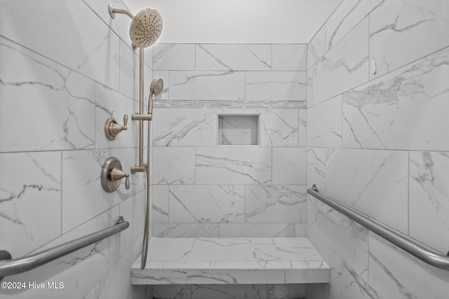 bathroom with tiled shower