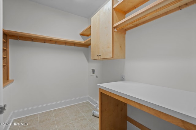 clothes washing area featuring cabinets and hookup for a washing machine