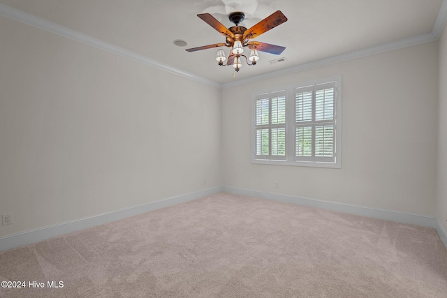 carpeted spare room featuring ceiling fan and crown molding