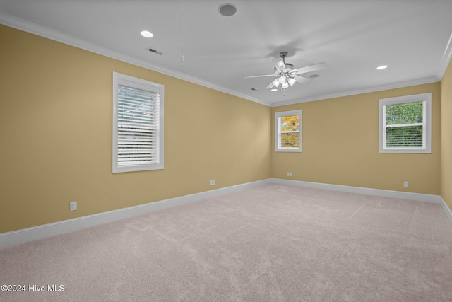 carpeted empty room featuring crown molding and ceiling fan