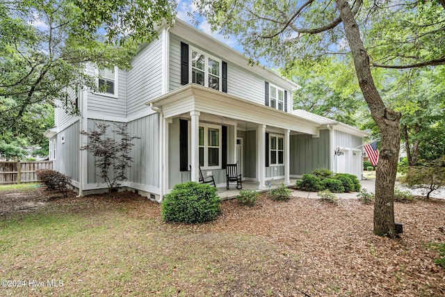 view of front facade featuring covered porch and a garage