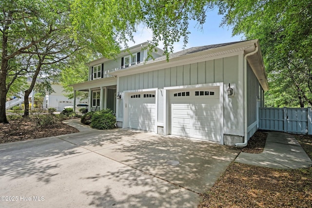 view of front of property featuring an attached garage, board and batten siding, and concrete driveway