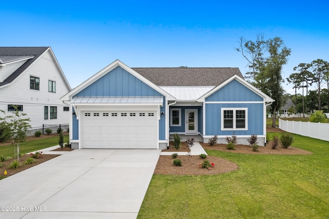 457 Raven Glen Dr, Southport, NC 28461 - view of front of house with board and batten siding, an attached garage, a standing seam roof, driveway, and metal roof
