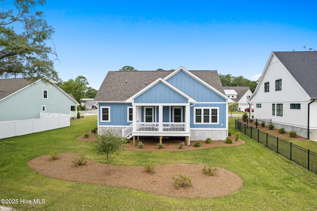 457 Raven Glen Dr, Southport, NC 28461 - back of house with board and batten siding, a porch, and roof with shingles