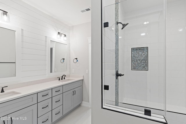 457 Raven Glen Dr, Southport, NC 28461 - bathroom with double vanity, a tile shower, tile patterned flooring, and baseboards