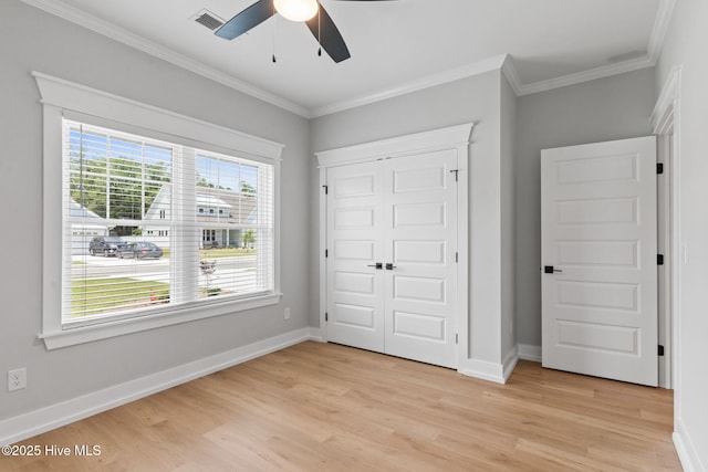 457 Raven Glen Dr, Southport, NC 28461 - unfurnished bedroom featuring light wood-style floors, crown molding, a closet, baseboards, and a ceiling fan