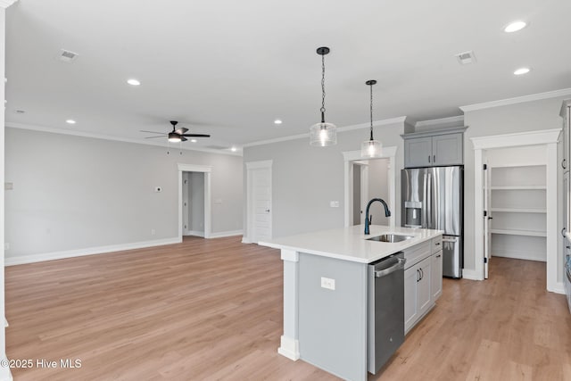 457 Raven Glen Dr, Southport, NC 28461 - kitchen with stainless steel appliances, ceiling fan, a sink, recessed lighting, and a center island with sink
